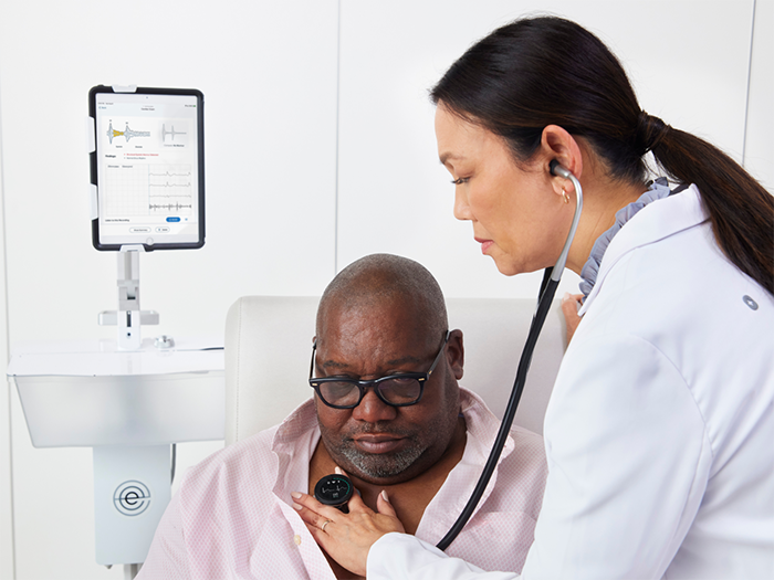 Clinician listens to patient's heart with CORE 500™ Digital Stethoscope